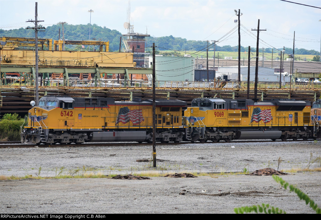 UP Engines Lead a SB CSX Train as NSs Main Tower Looks On